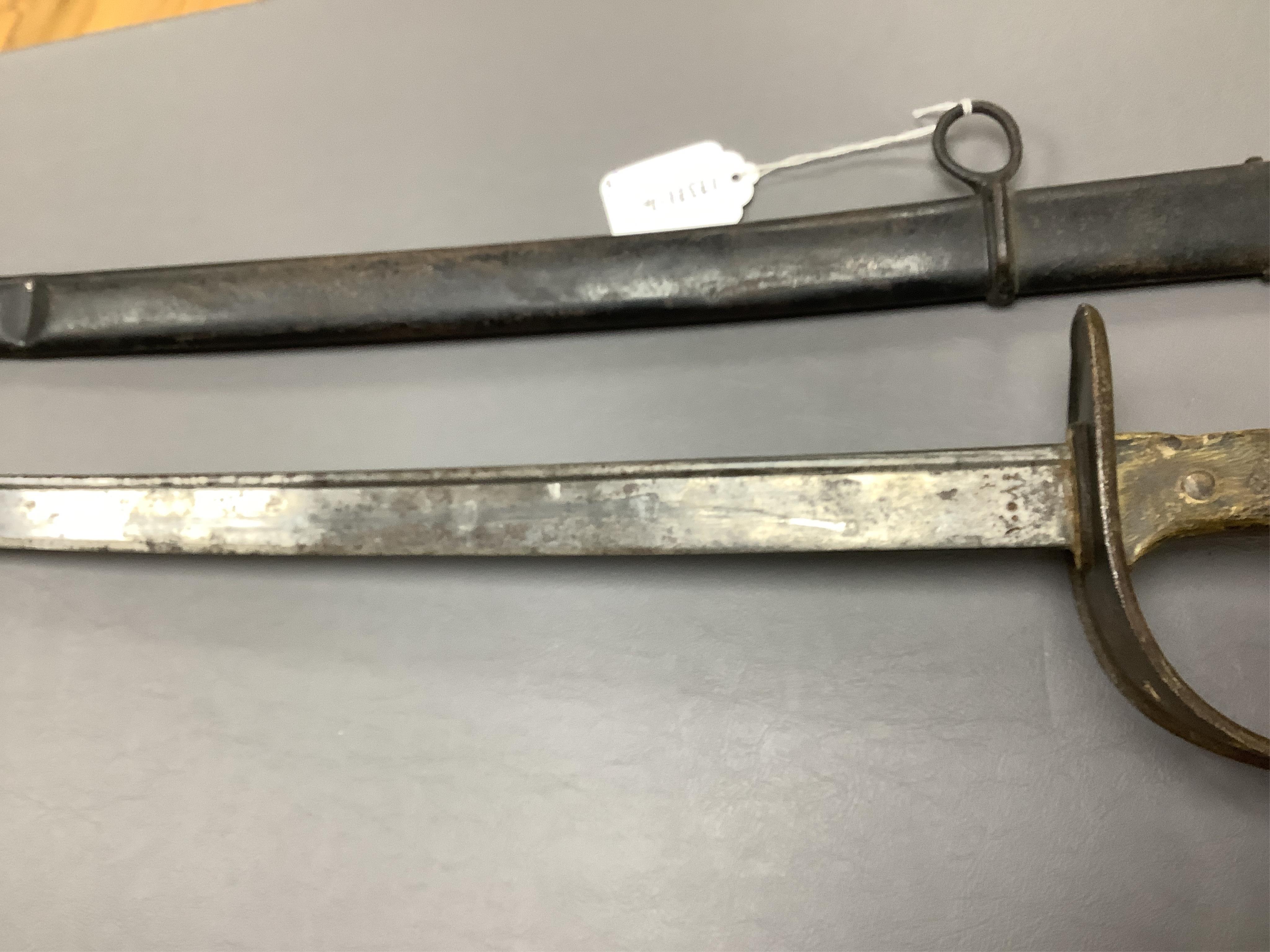 A First World War Turkish army officer’s sword, with pipe back blade, regulation iron guard pierced with crescent and moon, chequered horn grips, in its iron scabbard, together with an unidentified bayonet in its scabbar